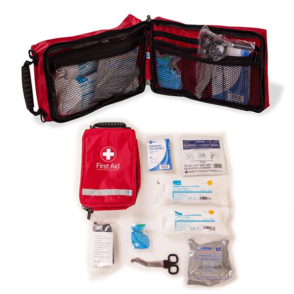 pen Cuteeze Bleed Control Kit from Defib Store Ltd, featuring essential first aid supplies, including gauze, a tourniquet, bandages, and haemostatic agents, all arranged neatly beside the red carry pouch with a white first aid cross, ready for quick emerg