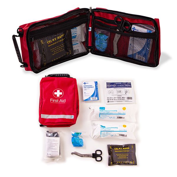 Compact and portable first aid Celox Bleed Control Kit open to display essential medical supplies including Celox granules, tourniquet, scissors, various bandages, and instructions, all housed in a red bag with a white cross for rapid bleed management and