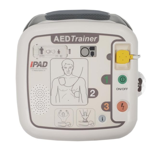 White C U Medical iPAD SP1 training defibrillator showing pad placement on adult patient with automatic shock button