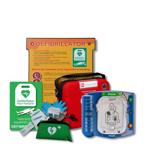 Image of the Philips Heartstart HS1 Defibrillator package available from Defib Store, which includes a white indoor AED cabinet, a slim carry case, an indoor AED wall sign, and a patient preparation kit. The white cabinet provides a secure storage solutio