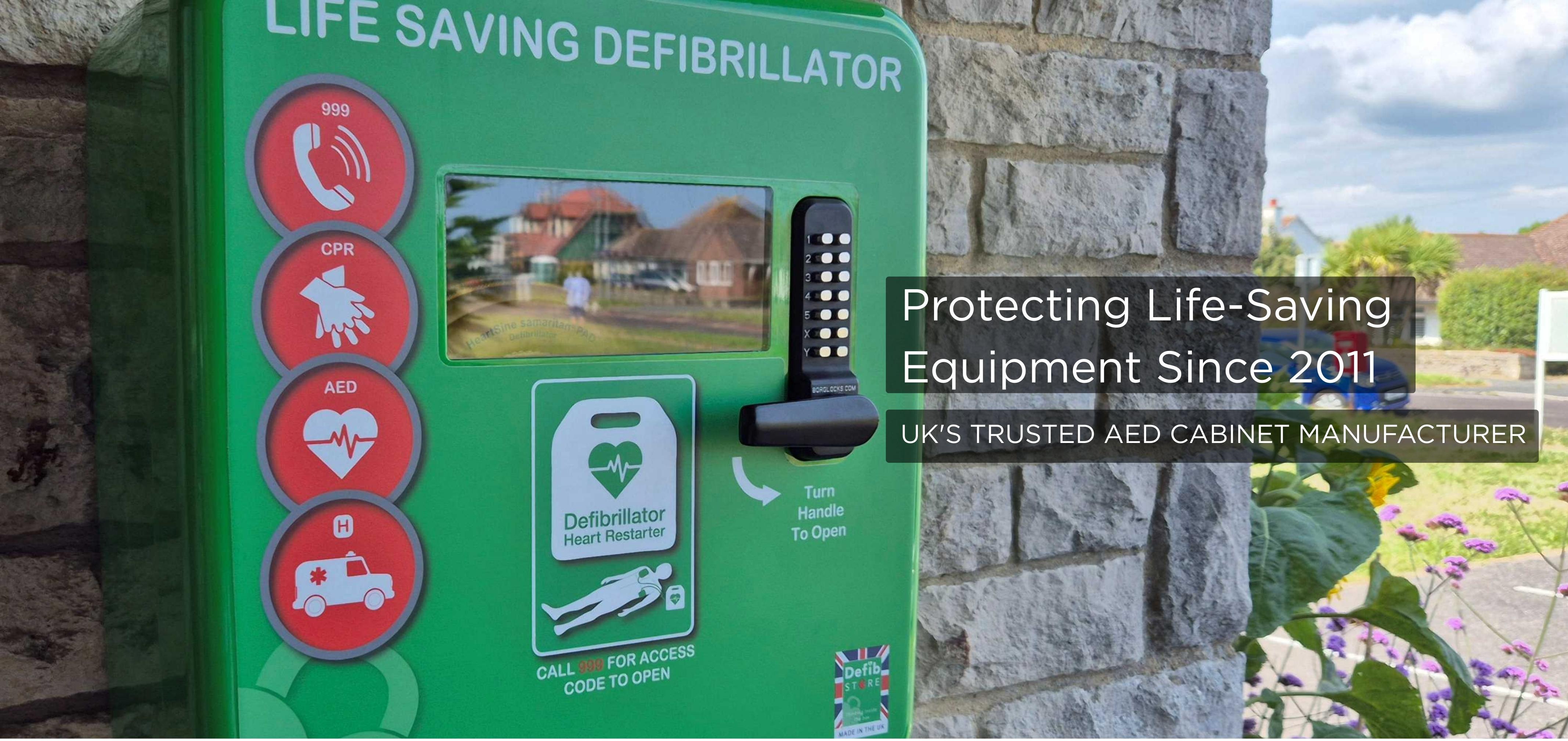 Defibstore AED Cabinet - UK Manufactured Defibstore green outdoor defibrillator cabinet installed on stone wall in UK community